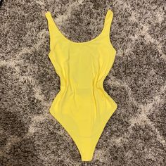 Size Small Brand New, Never Worn. Super Soft, Stretchy Double Layered Material. Color In Person Is More Of A Banana Color. Perfect Color For Spring And Summer Offers Always Welcome All Items Are Brand New And Unused Unless Stated Otherwise. Casual Sleeveless Bodysuit For Sunbathing, Chic Scoop Neck Swimwear For Summer, Trendy Solid Color Bodysuit For Pool, Trendy Solid Color Bodysuit For The Pool, Trendy Bodysuit For Pool, Summer Stretch One-piece Bodysuit, Casual Solid Color One Pieces For Summer, Fitted Casual Bodysuit For Sunbathing, Trendy Sleeveless Bodysuit For Sunbathing