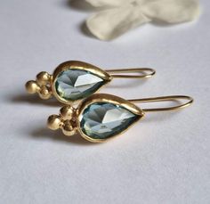 Blue Topaz Earrings, Teardrop earrings, Gemstone Earrings, Antique earrings, 14k gold earrings, December Birthstone Earrings, Vintage These Vintage inspired Teardrop earrings were designed and set with beautiful, pear shaped Blue Topaz. The 14k Gold earrings are 100% handmade and are romantic, elegant and beautiful. The earrings are shaped as teardrops, with a triangle of 3 golden dots at the edge of every such drop. The December Birthstone earrings are a great gift for you or your December birthday loved one. The earrings are available in multiple gemstones as you can see in the last photo and on the model. Dimensions: The pear shaped gemstone is 8X12 mm, in a facet cut. The Earring design is 2cm long and 0.9cm wide (0.8" and 0.35") Total drop is about 3cm (1.2") Materials: The Blue gemst Antique Turquoise Jewelry, Antique Turquoise, Blue Topaz Earrings, Topaz Earrings, Birthstone Earring, Antique Earrings, Delicate Earrings, Gold Drop Earrings, Gold Plated Jewelry