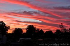 the sky is pink and blue with clouds