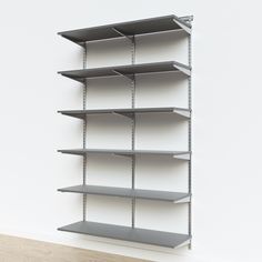 an empty shelving unit in a white room