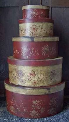 a red and gold wedding cake sitting on top of a table