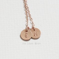 "Our tiny initial necklace is dainty and meaningful. This classic necklace is great for everyday wear or layering. Choose your number of discs and metal to wear your favorite initials close to your heart. D E T A I L S -Choose from 1-3 tiny discs -Disc measures 8mm -Choose 14kt Gold-Filled, Sterling Silver, or Rose Gold-Filled. -A high quality delicate link chain with a spring clasp. -Polished to a light satin finish. CUSTOM HAND STAMPING -Hand stamped with an initial. -This disc can also be lef