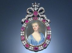 CHRISTIAN FRIEDRICH ZINCKE, (GERMAN 1683/4-1767).  Portrait of a lady wearing dècollète blue dress with white under slip and  blond upswept hair, enamel, to a later ruby and diamond frame with ribbon tied bow surmount, oval, 46mm x 38mm, later fitted case by Frazer & Haws, 31 Regent St, Piccadilly. 1700s Jewelry, Jewellery Painting, Portrait Jewelry, Diamond Frame, John Smith, Indian Jewellery Design Earrings, Bow Jewelry