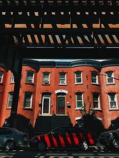 cars are parked in front of an apartment building