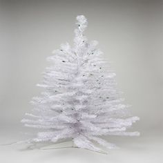 a white christmas tree with snow on it