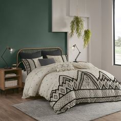 a bedroom with green walls and white bedding