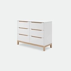 a white dresser with four drawers and two wooden legs