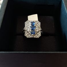 BRAND NEW IN BOX VINTAGE 2008 GENERATIONS 1912 W.B STERLING SILVER 1.24CT KANCHANABURI SAPPHIRE BLUE & WHITE SAPPHIRE RING. Kanchanaburi Sapphires are beautiful, rare, twilight blue gemstones from Thailand's Kanchanaburi Province, best known for the famous Bridge over the River Kwai. With no significant mining since 2009, the genuine rarity of Kanchanaburi Sapphire is undeniable. SIZE- Q FACE LENGTH- 2CM FACE WIDTH- 1.5CM KANCHANABURI SAPPHIRE- 4MM X 4MM APPROX EACH X 3 BLUE. HALLMARKED AND STAM Twilight Blue, Saphir Ring, White Sapphire Ring, Sapphire Blue, Blue Gemstones, White Sapphire, Vintage Sterling Silver, Rings Statement, Sapphire Ring