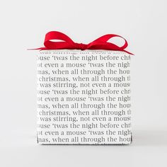 a gift box with a red ribbon tied around it's neck and the words, just was this night before christmas