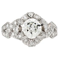 Finely crafted in platinum with a center Old-European cut diamond weighing 1.20 carats. L color and VS2-VS1 clarity The ring features surrounding diamonds weighing approximately a total of 1.00 carat.  Art Deco, circa 1920s-1930s.  Size 8, resizable. Art Deco Diamond Ring With Vvs Clarity, Art Deco Platinum Cluster Ring With Brilliant Cut, Luxury Art Deco Platinum Cluster Ring, Art Deco Platinum Diamond Ring With Vvs Clarity, European Cut Engagement Ring, Cartier 1895 Engagement Ring, European Cut Diamond Engagement Ring, Engagement Ring Art Deco, Wine Tote