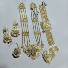 This is Handmade  Punjabi Handmade One Gram Gold Choker Necklace Ranihaar Set With Hair Jewelery / Punjabi Full Bridal Jewelery / Lavvan Jewelery / Pearl Gold Choker Set With Earings And Mangtikka For Women And Girls/ Jadau Jewelery / Jadau Earings / Punjabi Wedding Set / Indian Wedding Set / Jaggo Set / Traditional Morni Earings / Sangeet Jewelery Thank You :) Traditional Gold Sets With Zari Work, Traditional Gold Sets For Festive Occasions, Heavy Bridal Sets For Diwali Puja, Heavy Bridal Sets For Puja During Diwali, Traditional Gold Sets For Navratri, Traditional Gold Sets For Festivals, Gold Traditional Wear With Dabka For Navratri, Gold Traditional Sets For Festivals, Heavy Bridal Sets For Puja And Festive Occasions