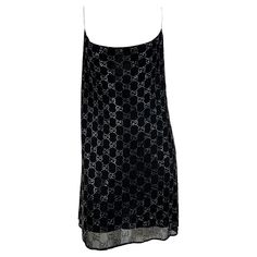 Presenting the rhinestone 'GG' Gucci slip dress of your dreams, designed by Tom Ford. From the Spring/Summer 1998 collection, this incredibly rare dress is constructed of two layers: an interior black slip and an exterior sheer layer covered in rhinestones in Gucci's famous 'GG' monogram pattern. The dress features a wide scoop neckline and spaghetti straps. Rihanna recently wore a similar Gucci by Tom Ford dress to the Gucci after-show party in February of 2022. The cropped shirt version of thi Gucci Sequin Dress, Gucci Luxury Cocktail Mini Dress, Gucci Vintage Dresses, Gucci Luxury Mini Dress, Gucci Luxury Mini Dress For Cocktail, Gucci Corset Dress, Luxury Gucci Cocktail Mini Dress, Luxury Gucci Mini Dress For Cocktail, Luxury Gucci Designer Mini Dress