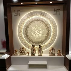 a display case with figurines in front of a circular design on the wall