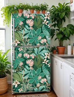 a refrigerator covered in lots of green plants next to a sink and potted plants