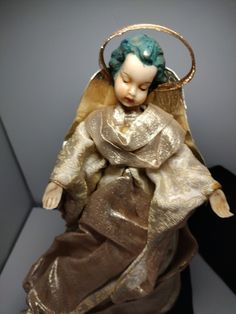 an angel figurine sitting on top of a table