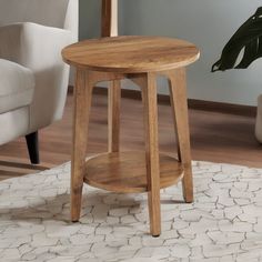 a small wooden table sitting on top of a white rug in front of a chair