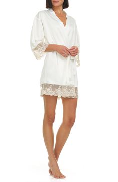 A lustrous satin robe edged with sheer floral lace is sure to make your mornings and evenings a little bit sweeter. 35 1/2" length (size Medium) Shawl collar Three-quarter sleeves Removable tie belt 100% polyester Hand wash, dry flat Imported Feminine Lace Robe For Wedding Night, Cream Satin Robe For Wedding Night, Cream Lace-trim Sleepwear For Wedding, Fitted Lace Robe For Wedding Night, Cream Wedding Sleepwear With Lace Trim, Spring Silk Sleepwear With Lace Trim, Elegant Lace Robe With Lace Cuffs, Elegant Delicate Lace Robe For Wedding Night, White Lace Trim Robe For Wedding Night