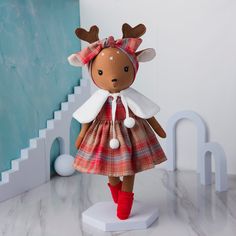 a stuffed animal wearing a dress and red boots