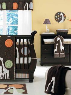 a baby crib bedding set with giraffes and circles on it