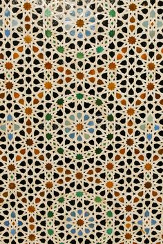 an intricate pattern on the outside wall of a building in kuwait, with many colors and shapes