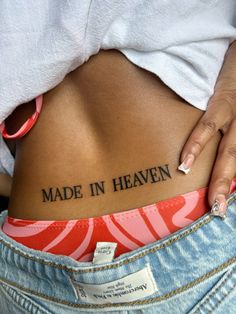 a woman's stomach with the words made in heaven written on her lower back