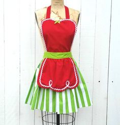 a green and white striped apron on a mannequin with red trimmings