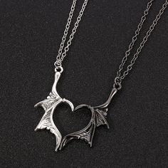 Elevate your love with the Dragon Wing Love Necklace, a symbol of unique and everlasting affection. Crafted with meticulous detail, this stunning piece features two intricately designed dragon wings, united in perfect harmony. Each wing is expertly crafted from premium quality metal and polished to a gleaming finish, creating a captivating and eye-catching accessory. The Dragon Wing Love Necklace is more than just jewelry; it's a statement of devotion and admiration. Whether you're expressing yo Demon Dragon, Dragon Wing, Necklace Couple, Jewelry Valentines Day, Bff Jewelry, Bracelet Viking, Friendship Necklace, Biker Jewelry, Dragon Necklace