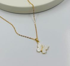 "Dainty necklace and Elegant to add to any outfit. It is the perfect gift for many celebrations such as birthdays, Gifts for the Wife, and Mother's Day. This Delicate 18 K Gold Butterfly Cubic Zirconia Charm is available in 16\" 14K Dainty Necklace Chain Gold for Layering. Chain Style:  Ball Chain 1,5 mm w/2\" Extender Chain. Diamond Chain 1 mm w/2\" Extender Chain. Oval Chain 1 mm w/2\" Extender Chain. You can also write to me if you need any information about the Necklace or have any questions Butterfly Charm Pendant Necklace For Gift, Butterfly Charm Pendant Necklace As Gift, Adjustable White Charm Necklace For Birthday, White Pendant Charm Necklace For Birthday, Handmade White Charm Necklaces For Birthday Gift, Dainty White Charm Necklaces For Birthday Gift, Butterfly Pendant Necklace For Mother's Day, Dainty White Charm Necklace For Birthday Gift, Handmade White Charm Necklaces For Mother's Day