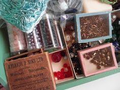 various items are displayed on a shelf in a display case, including beads and other things