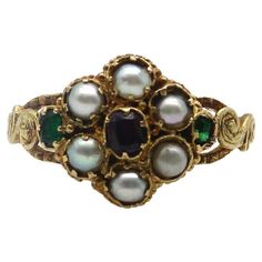 Here at Kirsten’s Corner, we have a sweet spot for these early Victorian flower rings. This 15k gold ring is reminiscent of a Forget-Me-Not flower, a popular motif in the Victorian era. The pearl flower petals in the ring represent tears and capture the romance in our hearts. A central garnet sits delicately amidst a lacy background, while two Old Emerald Cut emeralds add a pop of green to each side of the flower. Each stone is prong set into an early Victorian setting that was traditional for these types of rings. Along the sides is scrolling foliate, hand detailed to look like leaves. A lovely engraving goes all the way around the band of the ring, even detailing the edges of the band. Circa 1850, this is a very old ring that conveys sentimentality and everlasting love. The garnet measur 16th Century Jewelry, Antique Engagement Rings Victorian, Antique Emerald Engagement Ring, Victorian Wedding Ring, Green Engagement Rings, Antique Rings Victorian, Victorian Style Rings, Avon Rings, Vintage Jewelry Antique