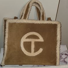 Classic Color Ugg Telfar Bag. New Worn Once. Designer Medium Bags For Everyday Use, Designer Tan Bags For On-the-go, Designer Everyday Tan Shoulder Bag, Designer Tan Shoulder Bag For Everyday Use, Designer Medium Shoulder Bag For Everyday Use, Designer Tan Satchel For Everyday, Tan Medium Shoulder Bag For Everyday Use, Ugg Telfar Bag, Ugg Telfar