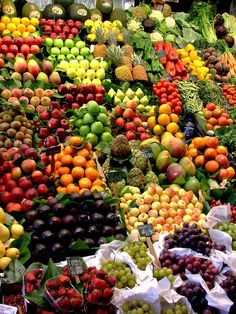 many different types of fruits and vegetables on display