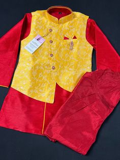 Boys Kurta Pajama Set with Jacket in Floral Weave Work. Yellow color Jacket with Floral Weaving Work with matching Kurta Brooch and buttons. The bottom is a matching color Balloon style. The Combination of Red, Maroon and Yellow makes the Kurta wearable for all the occasion. Item : Boys Kurta Pajama Ready to Wear : Yes Kurta Color : Yellow and Red Pajama Color : Maroon (Balloon Style) Fabric : Silk Pocket : Yes Lining : Yes Disclaimer - There can be little variation in the color due to screen re Festive Sets With Zari Work On Straight Kurta, Bollywood Style Art Silk Sets For Eid, Bollywood Art Silk Sets For Eid, Festive Designer Sets With Front Open Design, Festive Designer Sets With Front Open, Multicolor Bandhgala For Festive Occasions, Self Design Saree Set For Celebrations, Festive Front Open Designer Sets, Celebration Saree Set With Self Design