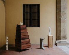 several pieces of wood stacked on top of each other in front of an open window