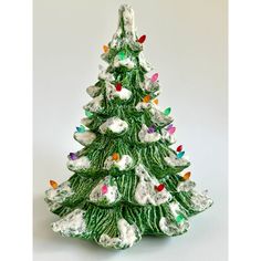 a ceramic christmas tree with lights on it