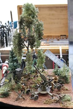 an assortment of toy army vehicles and trees