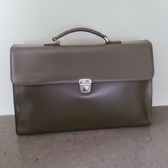 Stunning Furla Bag In Olive Leather With Inner Suede Lining On Front Flap And Silver Clasp Closure. Top Handle With Removable Shoulder Strap. Interior Features Two Large Opening Separated By Zip Section. Great As A Large Satchel Or Bag For Business. Measures 16” Wide X 10” High X 4.5” Deep. 39” Removable Strap. Small Mark On Edge Of Top Handle And Under Front Flap As Shown In Photos, Otherwise Excellent Condition. Original Dust Bag Included. Designer Bags With Hasp Closure For Formal Occasions, Designer Green Business Bag, Elegant Leather Briefcase With Hasp Closure, Classic Briefcase With Hasp Closure For Daily Use, Formal Leather Bag With Hasp Closure, Classic Briefcase With Hasp Closure For Formal Use, Formal Leather Briefcase With Hasp Closure, Classic Business Briefcase With Hasp Closure, Elegant Formal Briefcase With Hasp Closure