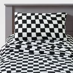 a black and white checkered comforter set on a bed