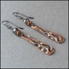 "These unique lightweight earrings feature one-of-a-kind dangles of artisan copper. The metal displays a deeply rippled, rich organic texture formed by dried corn husks. I oxidized it to a dark charcoal gray and polished the high points for striking contrast. The shiny dangles are accented with antique copper nugget beads and dark gray-black labradorite stones. The high-quality gemstones are sharply faceted and very reflective. Finished with oxidized sterling silver, these unusual earrings are q Nickel-free Rust Drop Earrings, Artisan Nickel-free Rust-colored Jewelry, Artisan Rust Color Nickel-free Jewelry, Artisan Rust-colored Nickel-free Jewelry, Handmade Bronze Long Drop Jewelry, Copper Oxidized Finish Drop Earrings, Artisan Hand Forged Dangle Earrings, Rust Colored Hammered Copper Jewelry, Artisan Rust-colored Nickel-free Earrings