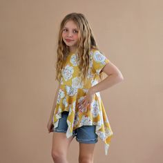 This fun, high-low boho shirt not only is chic in style but a comfy casual fit. 65% Cotton, 35% polyester We recommend hand washing and hang drying this article of clothing. Flowy Short Sleeve Tops For Fall, Bohemian Short Sleeve Tops For Spring, Casual High-low Hem Blouse For Fall, Spring Casual Tops With Curved Hem, Bohemian Yellow Summer Shirt, Casual Tops With Curved Hem For Spring, Casual Spring Tops With Curved Hem, Casual Asymmetrical Hem Blouse For Spring, Casual Shirt With Asymmetrical Hem And Relaxed Fit