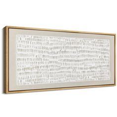 a white and gold framed wall hanging on the side of a wall with an abstract pattern