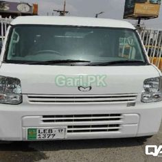 a white van parked in front of a gate