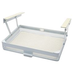 a white tray with an open lid and handle on the bottom is holding a small table top