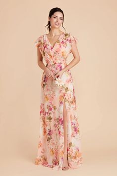 a woman in a floral dress posing for the camera