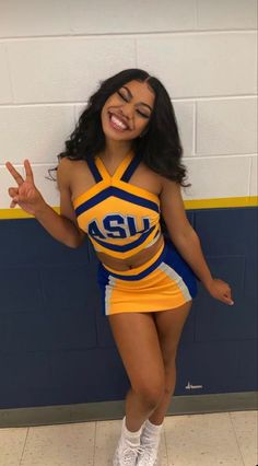 a woman in a cheerleader outfit posing for the camera