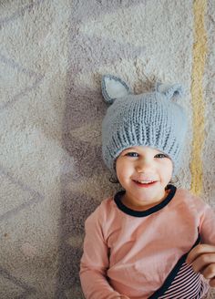 Our sweet bunny hat is perfect for new spring babes. These have a nice fit around the base of the hat that keeps it from getting stretched out. The color in the ears is such a simple but cozy detail. Bailey Bunny comes in three different colors: choose between White with Gray ears, White with Pink ears or Gray with White ears. Any color you decide will have you ﻿hopping﻿ with joy. Photo by: @andrea.coonrod Winter Novelty Cat Ears Hat, Novelty Cat Ears Winter Hat, Playful Winter Costume Hats And Headpieces, Playful Beanie Cap One Size Fits Most, Winter Hats For Playtime, Cute One Size Fits Most Beanie, Handmade Playful Winter Bonnet, Playful Handmade Winter Bonnet, Playful Warm Bonnet Cap