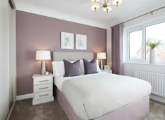 a bedroom with purple walls and white bedding