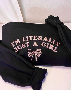 I'm Just a Girl Embroidered Crewneck With Bow (Pink Design). Please request custom threads colors via customization box. Otherwise embroidered as pictured -Soft & Comfortable: Made from a high-quality blend of cotton and polyester for ultimate comfort and durability. -Charming Design: Adorable "I'm literally just a girl" with a bow adds a playful touch to your outfit. -Embroidered Detail: Intricately embroidered for a premium look and feel. -Versatile Style Available in various sizes and colors Cute Long Sleeve T-shirt With Embroidered Text, Cute Winter Tops With Embroidered Text, Cute Pink T-shirt With Letter Embroidery, Cute Embroidered Winter Tops, Pink Long Sleeve Top With Letter Embroidery, Long Sleeve Pink Top With Embroidered Text, Pink Cotton Sweatshirt With Embroidered Graphics, Cotton Letter Print Sweatshirt, Pink Tops With Embroidered Text For Winter