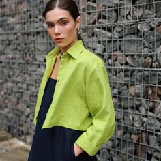 "Our Cropped Linen Shirt is a modern version of a button-up women's shirt. It features a relaxed fit with a back pleat and cuffed bracelet-length sleeves. The slightly cropped design is perfect for playing with proportions. Pair it with high-waisted skirts for casual days or try it with a flowing midi skirt to dress it up.  DETAILS ⚬ Pointed collar. ⚬ Front button closure. ⚬ Drop shoulders. ⚬ Cuffed bracelet-length sleeves. ⚬ Cropped length. ⚬ Made of organic Oeko-Tex-certified linen. ⚬ The linen is NOT see-through. ⚬ Shown here in Chartreuse Green. FIT / SIZE ⚬ Designed for a loose fit. ⚬ The front length (from the shoulder to the hem) is  ± 19\" (50 cm).  If you would like to add or subtract 10cm from the length, just let us know. ⚬ Sizes XXS to 7XL (please see detailed size chart in pho Spring Long Sleeve Cropped Shirt With Button Cuffs, Modern Shirt With Placket For Spring, Spring Cropped Button-up Shirt With Pockets, Spring Cropped Shirt With Buttons, Relaxed Fit, Relaxed Fit Cropped Shirt With Buttons For Spring, Long Sleeve Cropped Shirt For Daywear, Modern Spring Tops With Button Cuffs, Modern Long Sleeve Cropped Shirt For Work, Trendy Relaxed Fit Cropped Shirt With Buttons