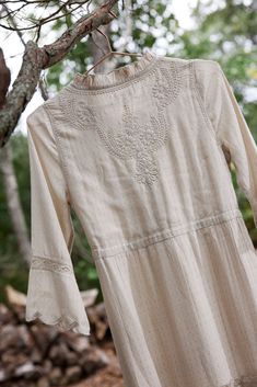 The Ahalya dress is a long, flowy , tiered dress with a prairie feel. It lives up to its name which means ' one with impeccable beauty'. It is perfect for transitional weather with its long sleeve and mock neck details. It features delicate Lucknowi hand embroidered motifs, scalloped edges and adjustable drawstring at waist with handmade tassels. Wear it in warmer weather with sandals or pair with your favorite boots and a vest for cooler months. The self patterned fabric gives it a simple, elev Lawn Dress Design, Dress Designing, Neck Details, Embroidered Motifs, Lawn Dress, Favorite Boots, Pink Maxi Dress, Scalloped Edges, Patterned Fabric